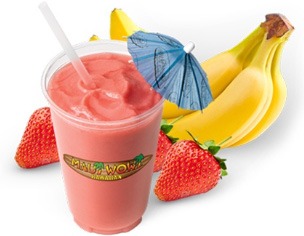 Frosty pink smoothie garnished with a small umbrella, surrounded by fresh strawberries and bananas, showcasing a tropical treat from a smoothie shop.