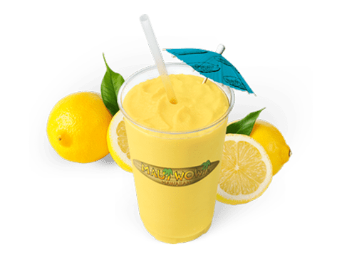 Refreshing lemon smoothie in a clear cup with a straw and an umbrella, surrounded by whole and sliced lemons, highlighting its tropical appeal.